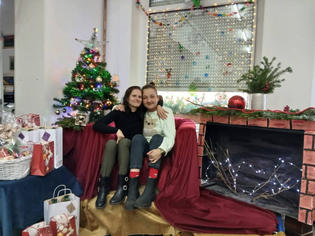 osoby pozujące przy scenografii światecznej